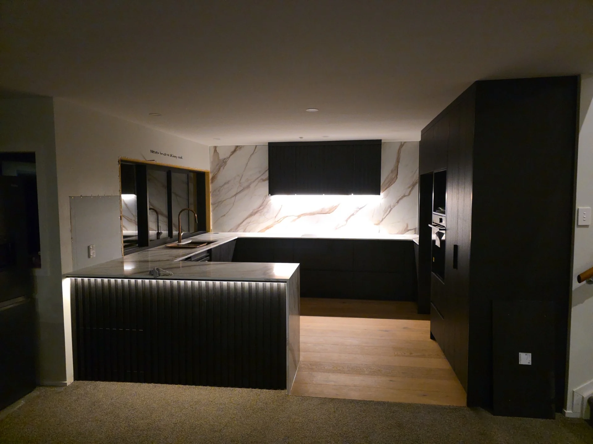 Kitchen installation with white cabinetry and detailed spatial planning